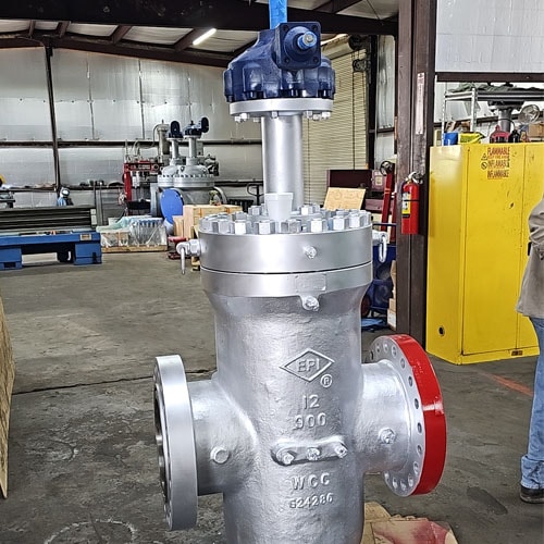 Silver EPI 12 inch 900 class gate valve with blue actuator and red flange in a workshop